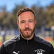 Coach Benjamin Denhez, smiling, wearing a black DC Eleven training jacket