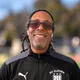 Coach Troy McLean, smiling, wearing sunglasses, a headband and a black DC Eleven training jacket